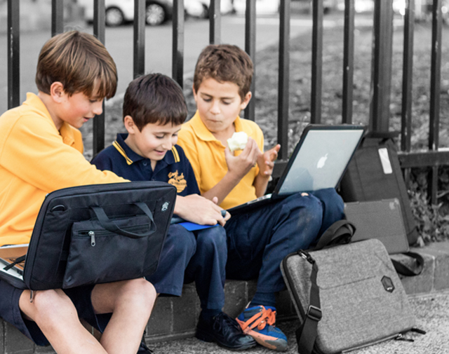 Three (3) children, with laptops