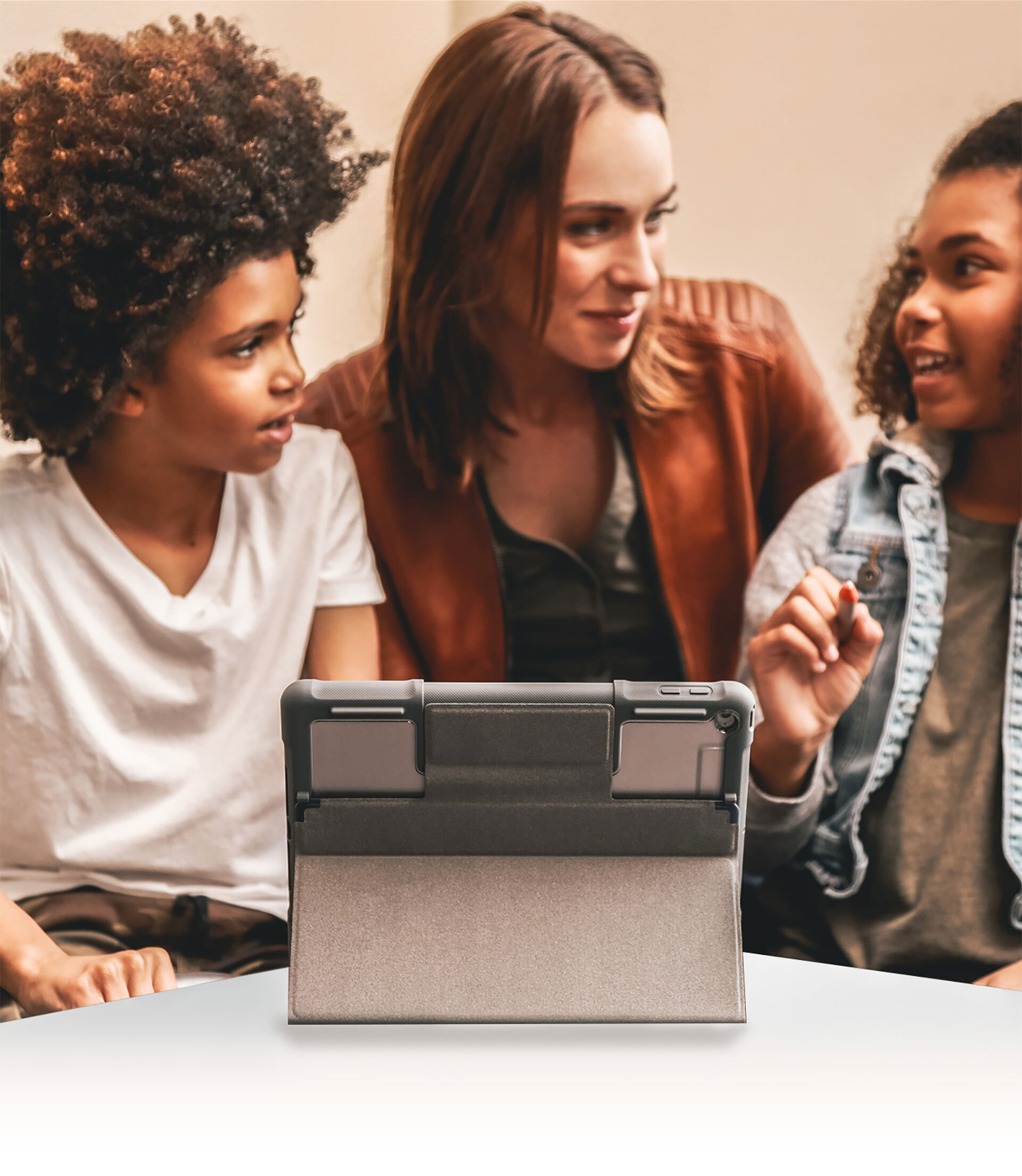 Three people in front of a propped-up laptop